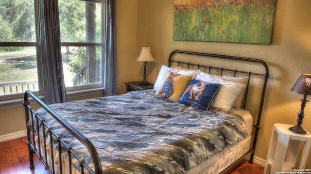 211 Roy Chisum Rd, Leakey, TX 78873 - bedroom with baseboards and wood finished floors