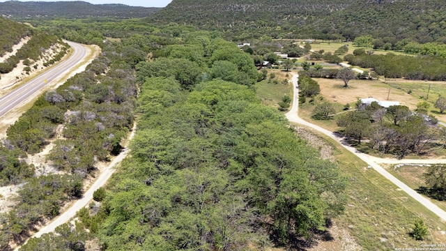 211 Roy Chisum Rd, Leakey, TX 78873 - aerial view of property and surrounding area with a forest and mountains