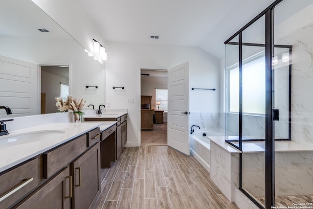 12531 Yancey, San Antonio, TX 78253 - bathroom featuring healthy amount of natural light, a bath, a stall shower, double vanity, and lofted ceiling