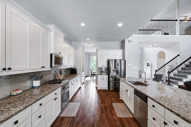 27210 Camellia, Boerne, TX 78015 - kitchen with appliances with stainless steel finishes, a sink, light stone countertops, white cabinets, and recessed lighting