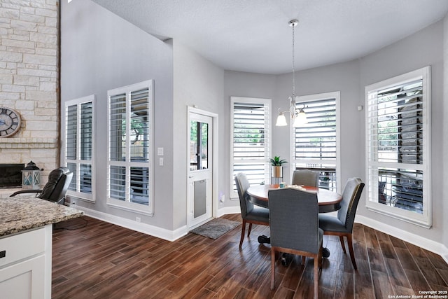 27210 Camellia, Boerne, TX 78015 - dining area featuring baseboards, dark wood-type flooring, and a fireplace