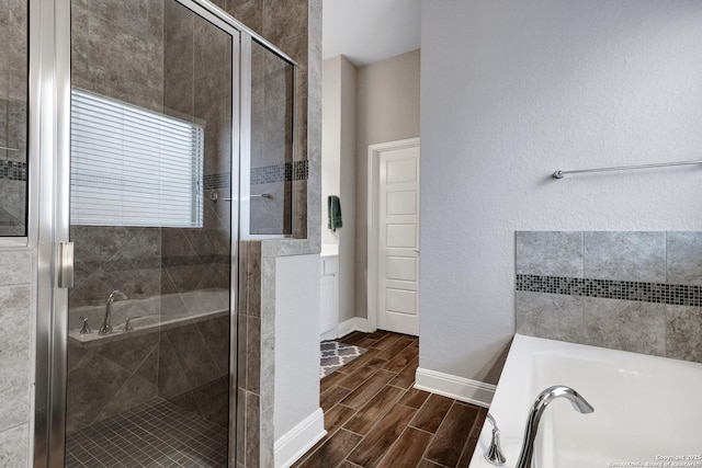 27210 Camellia, Boerne, TX 78015 - bathroom with a shower stall, a garden tub, wood tiled floors, and baseboards