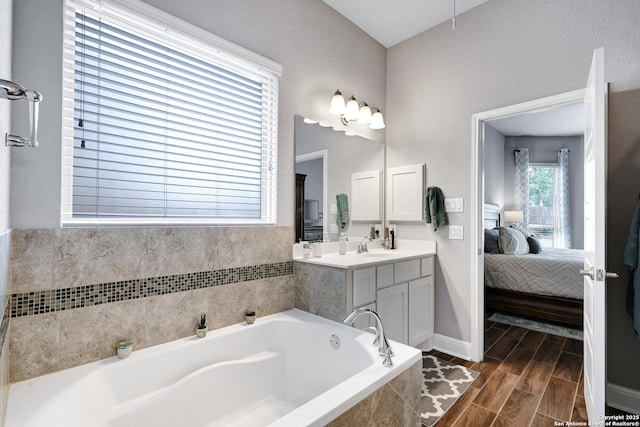 27210 Camellia, Boerne, TX 78015 - bathroom with ensuite bathroom, a bath, vanity, baseboards, and wood finished floors