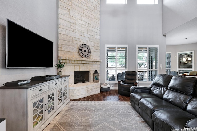 27210 Camellia, Boerne, TX 78015 - living room with dark wood-type flooring, a stone fireplace, and a towering ceiling