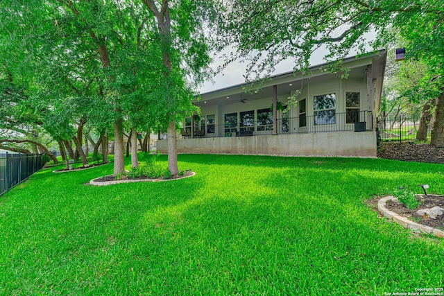 rear view of property featuring ceiling fan