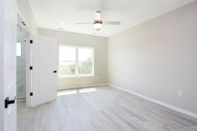 656 Canyon Cir, Canyon Lake, TX 78133 - unfurnished bedroom featuring light wood finished floors, baseboards, and ceiling fan