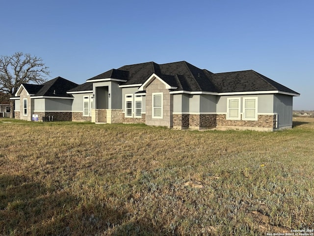 108 Estates Dr, La Vernia, TX 78121 - view of front of property featuring stone siding, a front lawn, stucco siding, and a shingled roof