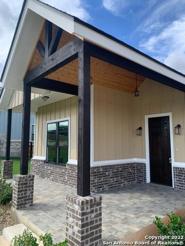 128 Woodbridge Ln, Vernia, TX 78121 - property entrance featuring brick siding and board and batten siding