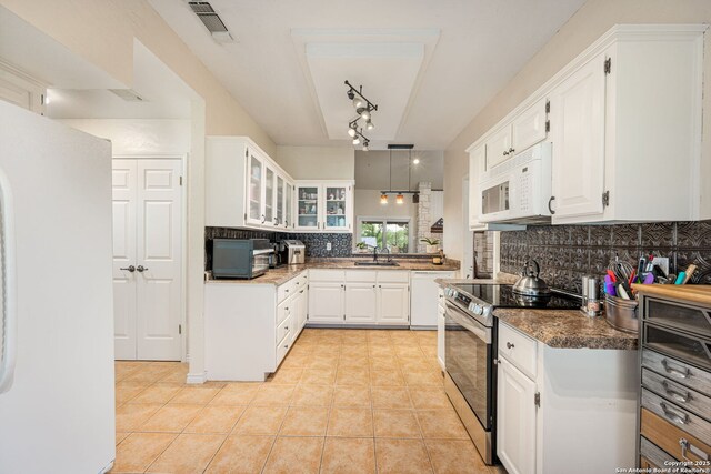 104 Holly Hl, Ingram, TX 78025 - kitchen with white appliances, decorative backsplash, a sink, glass insert cabinets, and light tile patterned flooring