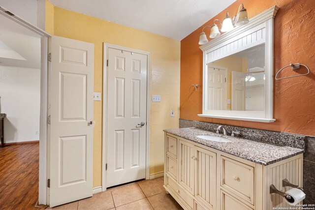 104 Holly Hl, Ingram, TX 78025 - bathroom with vanity, tile patterned floors, and a textured wall