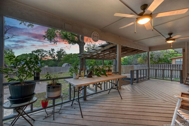 104 Holly Hl, Ingram, TX 78025 - deck at dusk with a fenced backyard and a ceiling fan
