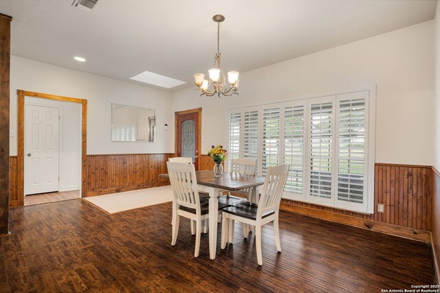 104 Holly Hl, Ingram, TX 78025 - dining room featuring wooden walls, wainscoting, a chandelier, wood finished floors, and recessed lighting