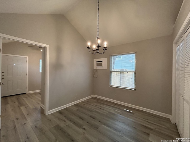 270 Oelkers, San Antonio, TX 78204 - unfurnished dining area featuring a chandelier, wood finished floors, baseboards, high vaulted ceiling, and an AC wall unit