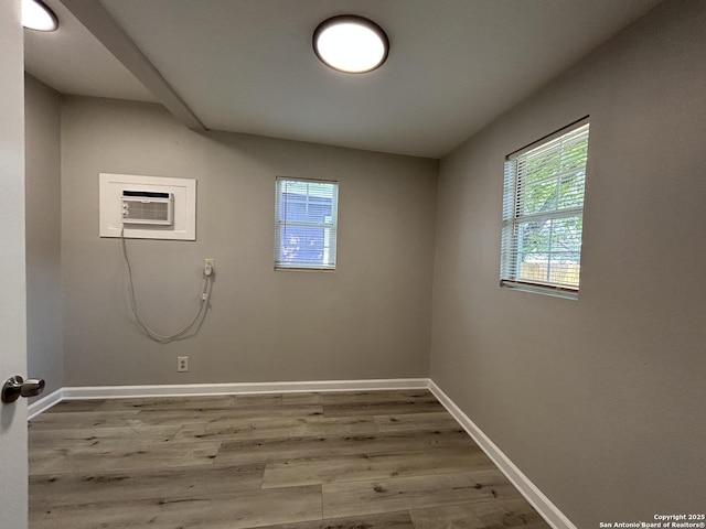 270 Oelkers, San Antonio, TX 78204 - clothes washing area featuring wood finished floors, baseboards, and a wall mounted AC