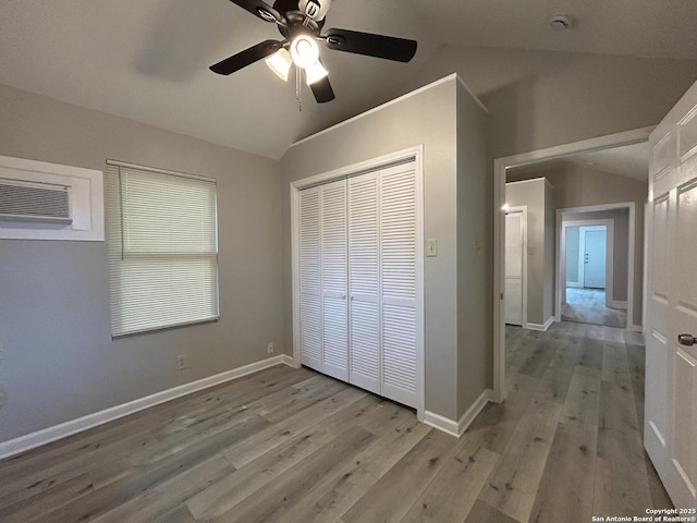 270 Oelkers, San Antonio, TX 78204 - unfurnished bedroom with lofted ceiling, wood finished floors, a closet, a wall mounted air conditioner, and ceiling fan