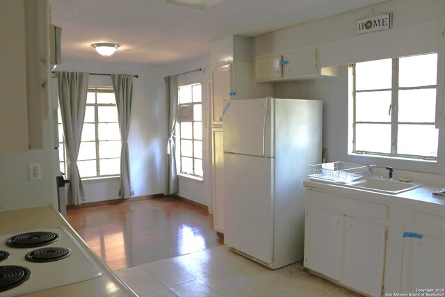 1306 Mountain Vw, Pipe Creek, TX 78063 - kitchen with freestanding refrigerator, plenty of natural light, and light countertops