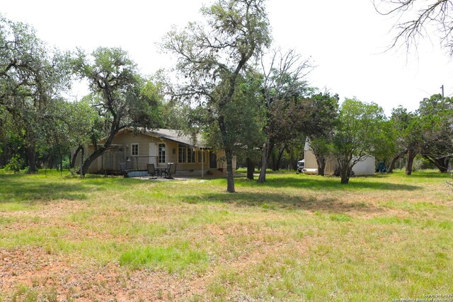 1306 Mountain Vw, Pipe Creek, TX 78063 - view of green lawn with a patio