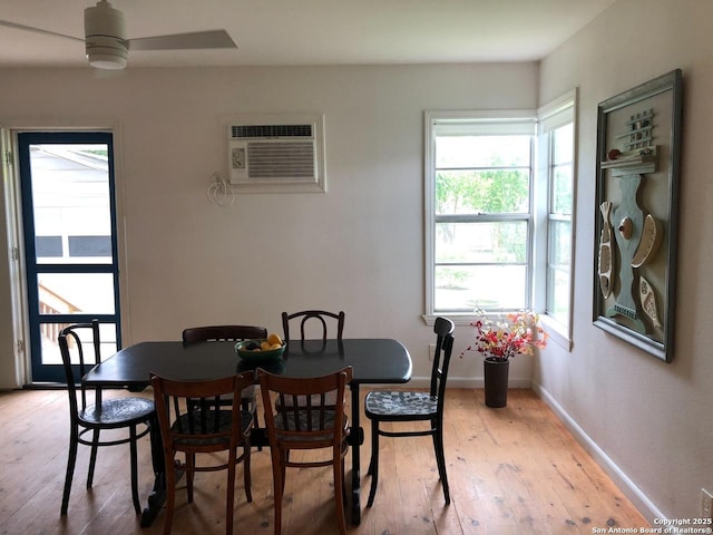 345 Westminster, San Antonio, TX 78228 - dining space with an AC wall unit, light wood-style flooring, a ceiling fan, and baseboards