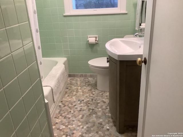 345 Westminster, San Antonio, TX 78228 - bathroom featuring vanity, toilet, tile walls, and tile patterned flooring