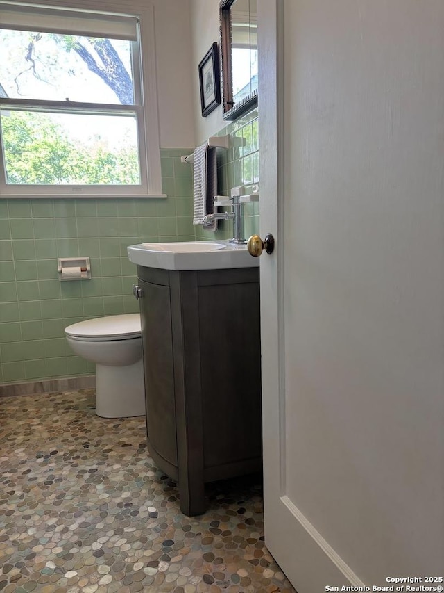 345 Westminster, San Antonio, TX 78228 - half bath featuring tile walls, toilet, vanity, and wainscoting