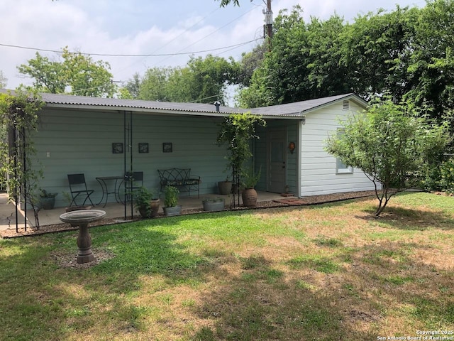 345 Westminster, San Antonio, TX 78228 - rear view of house with a yard, a patio area, and metal roof