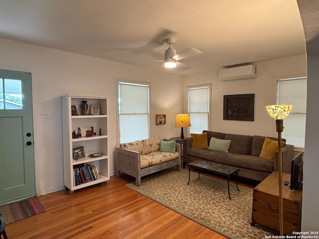 345 Westminster, San Antonio, TX 78228 - living room featuring a wall mounted AC, light wood finished floors, and a ceiling fan