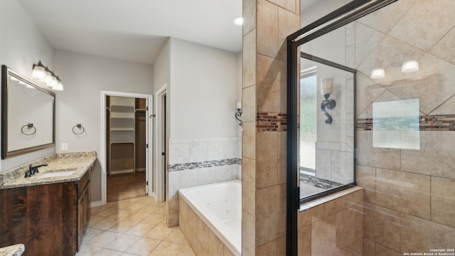 7881 Wegner, New Braunfels, TX 78132 - bathroom with a stall shower, tile patterned floors, a jetted tub, vanity, and a walk in closet
