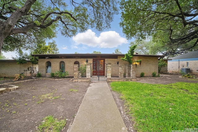 4006 Glenrock, San Antonio, TX 78240 - view of front of house with brick siding, cooling unit, and a front lawn