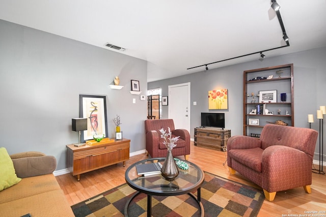 2811 Woodbury Unit 106, San Antonio, TX 78217 - living room with track lighting, light wood finished floors, and baseboards