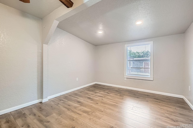 1022 Vickers Ave, San Antonio, TX 78211 - empty room featuring a textured ceiling, wood-type flooring, baseboards, a ceiling fan, and recessed lighting