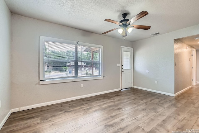 1022 Vickers Ave, San Antonio, TX 78211 - spare room with a textured ceiling, ceiling fan, wood finished floors, and baseboards