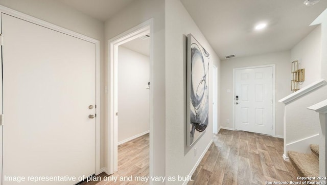 3014 Lindenwood Way, San Antonio, TX 78245 - foyer entrance featuring light wood-type flooring, stairway, and baseboards