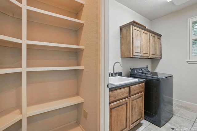 143 Roseheart, San Antonio, TX 78259 - laundry room with washer / dryer, cabinet space, and light tile patterned flooring