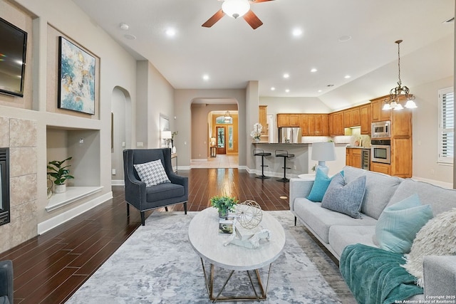 143 Roseheart, San Antonio, TX 78259 - living area with arched walkways, dark wood-type flooring, a ceiling fan, recessed lighting, and a tiled fireplace