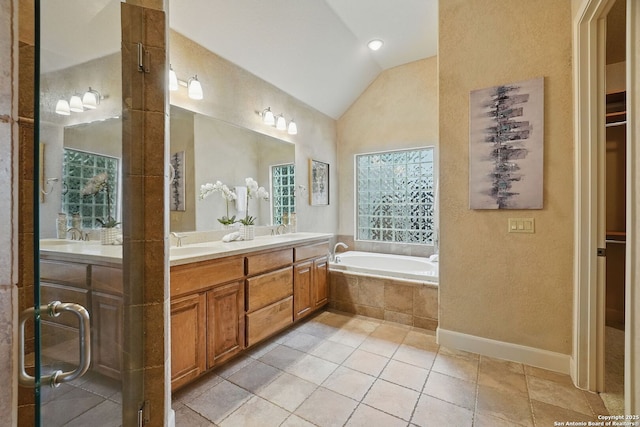 143 Roseheart, San Antonio, TX 78259 - full bathroom featuring vaulted ceiling, double vanity, a bath, a textured wall, and tile patterned flooring