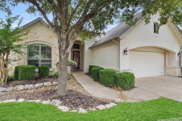 143 Roseheart, San Antonio, TX 78259 - view of front facade with stone siding, driveway, stucco siding, a shingled roof, and a garage