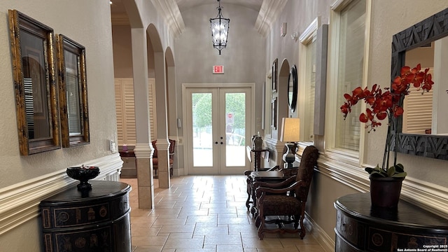 143 Roseheart, San Antonio, TX 78259 - foyer entrance featuring arched walkways, french doors, a chandelier, high vaulted ceiling, and stone tile floors