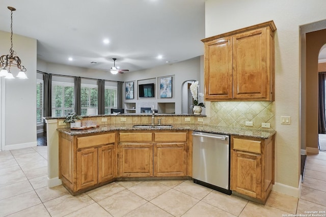 143 Roseheart, San Antonio, TX 78259 - kitchen featuring dishwasher, decorative backsplash, a peninsula, stone counters, and brown cabinets