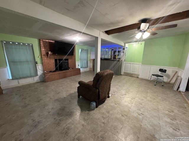 1702 Westmar, San Antonio, TX 78227 - living room with a fireplace, ceiling fan, beamed ceiling, and wainscoting