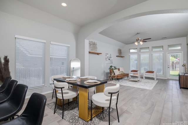 14703 Running Wolf, San Antonio, TX 78245 - dining area with arched walkways, a ceiling fan, baseboards, lofted ceiling, and light wood-style flooring
