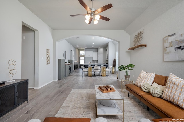14703 Running Wolf, San Antonio, TX 78245 - living room featuring arched walkways, light wood-style floors, a ceiling fan, and baseboards