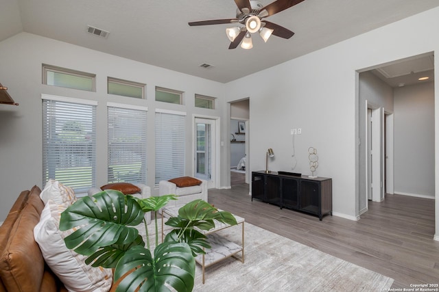 14703 Running Wolf, San Antonio, TX 78245 - living room featuring a ceiling fan, wood finished floors, vaulted ceiling, and baseboards