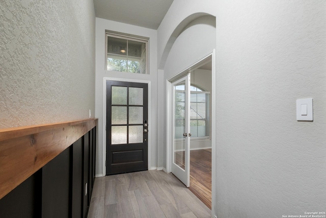 14703 Running Wolf, San Antonio, TX 78245 - doorway featuring a textured wall, light wood-style flooring, french doors, and baseboards
