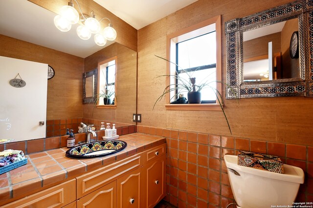 1211 Mount Riga, San Antonio, TX 78213 - bathroom with toilet, tile walls, and vanity