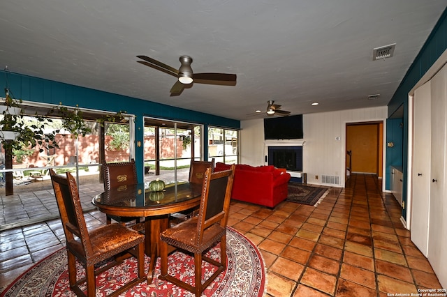 1211 Mount Riga, San Antonio, TX 78213 - dining area with a ceiling fan and a fireplace with raised hearth