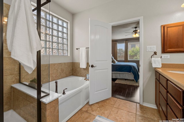 18010 Camino Del Mar, San Antonio, TX 78257 - bathroom with ensuite bathroom, vanity, a garden tub, ceiling fan, and tile patterned floors