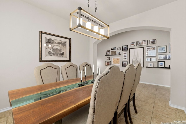 18010 Camino Del Mar, San Antonio, TX 78257 - dining space with light tile patterned floors, lofted ceiling, and baseboards