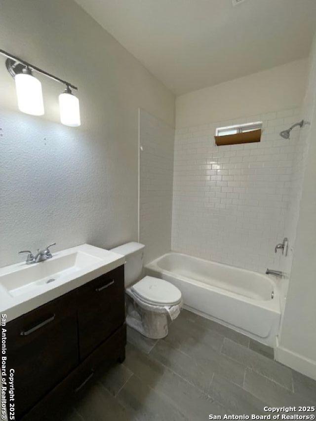 438 Vanderbilt, San Antonio, TX 78210 - bathroom featuring toilet, tub / shower combination, and vanity