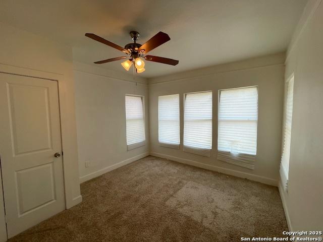 438 Vanderbilt, San Antonio, TX 78210 - unfurnished room with light carpet, a ceiling fan, and baseboards