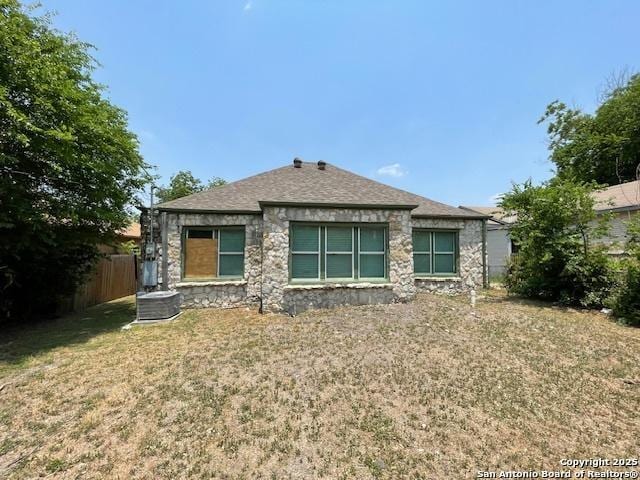 438 Vanderbilt, San Antonio, TX 78210 - rear view of house with stone siding, a shingled roof, and cooling unit